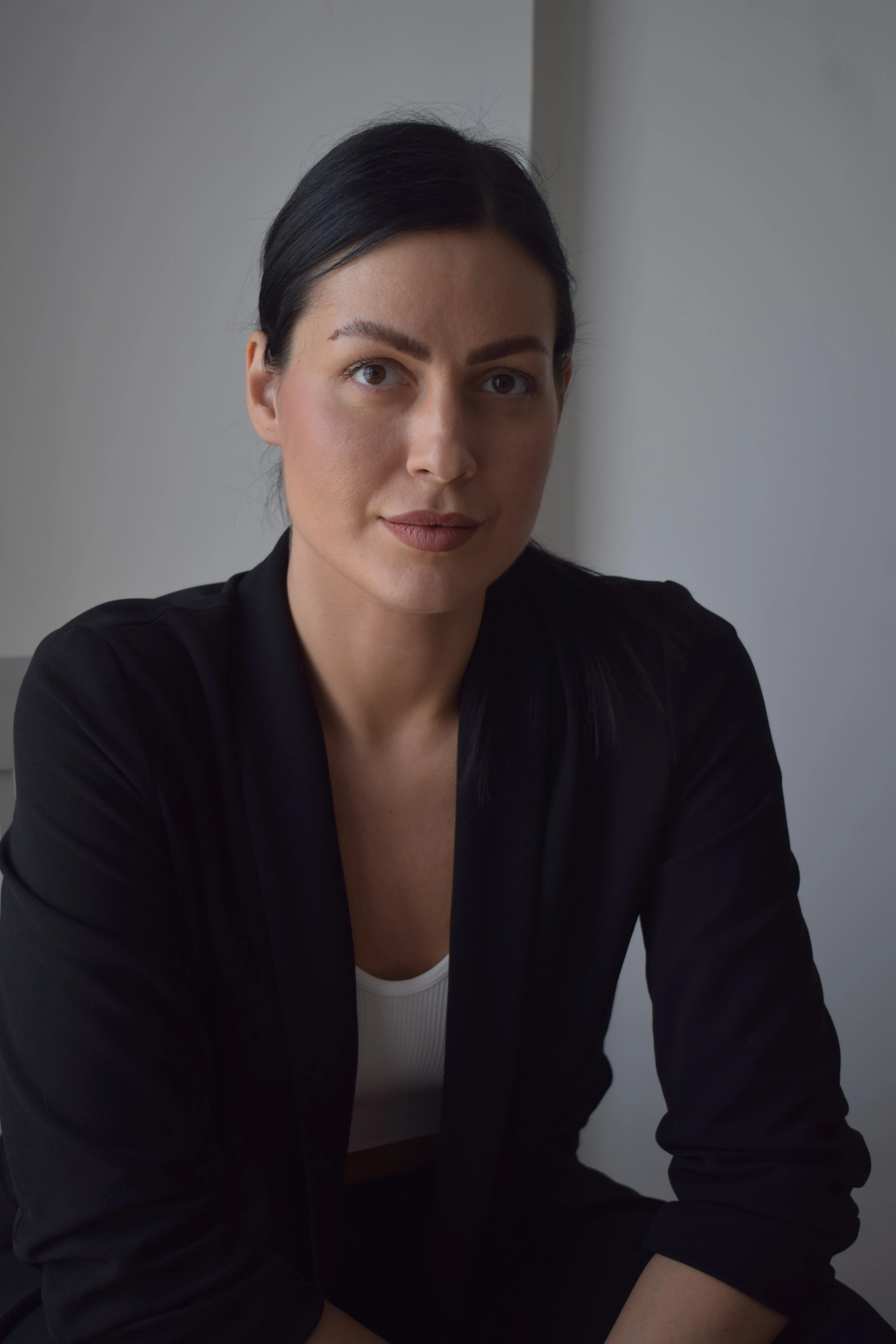 Professional corporate headshot in a black blazer, shot by Photoczaro in Dubai